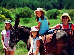 Family posing with their donkey on a family donkey trekking tour